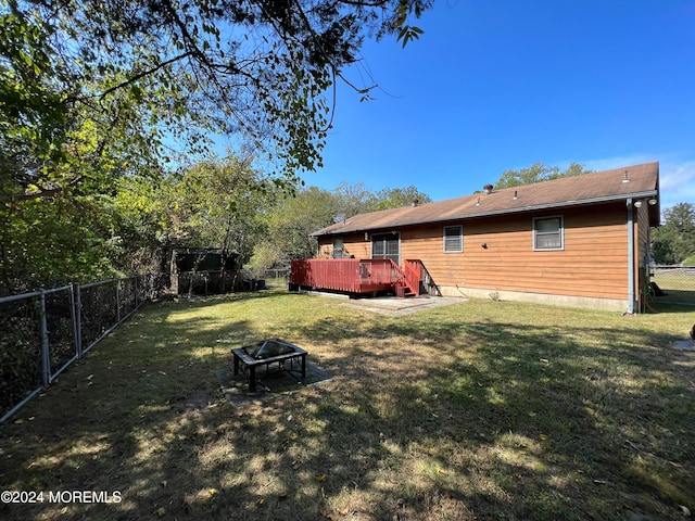 view of yard with a fire pit and a wooden deck