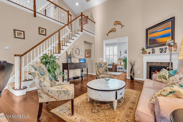 living room with hardwood / wood-style floors and high vaulted ceiling