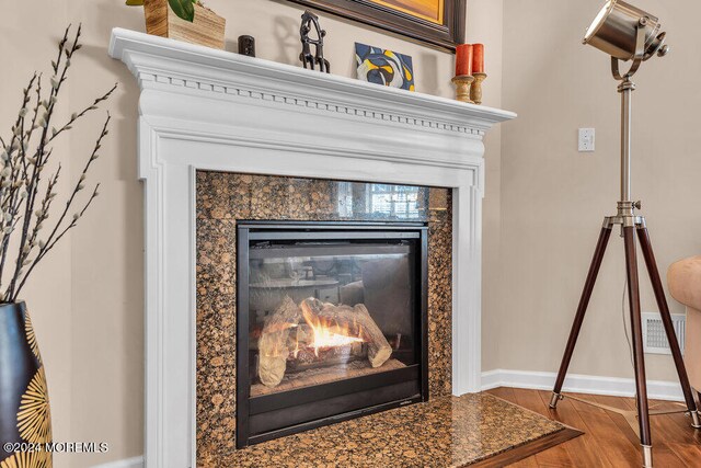 interior details featuring a fireplace and hardwood / wood-style floors