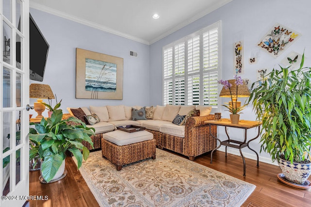 living room with french doors, ornamental molding, and wood-type flooring