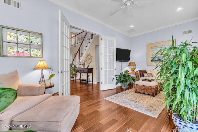 living room with french doors, hardwood / wood-style flooring, ceiling fan, and crown molding