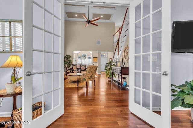 interior space featuring french doors, crown molding, wood-type flooring, and plenty of natural light