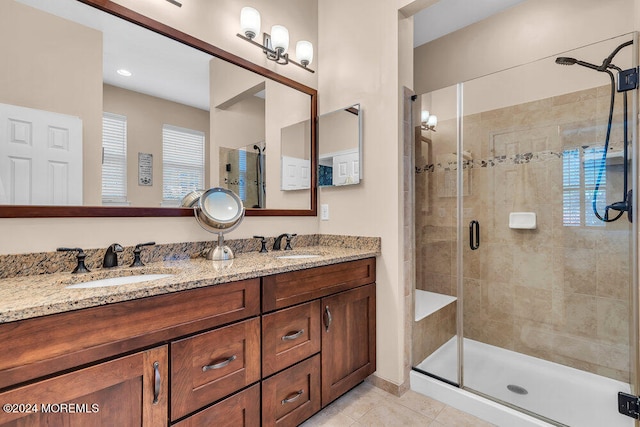 bathroom featuring vanity, an enclosed shower, and tile patterned flooring