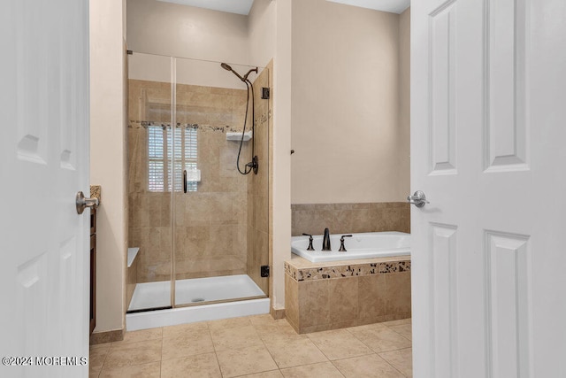 bathroom with shower with separate bathtub and tile patterned floors