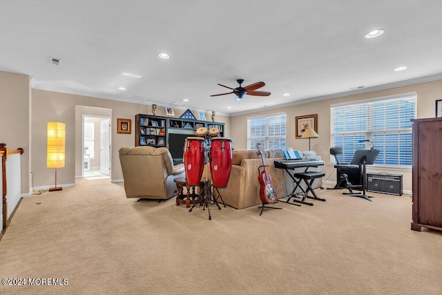 living room with a wealth of natural light, ornamental molding, light carpet, and ceiling fan