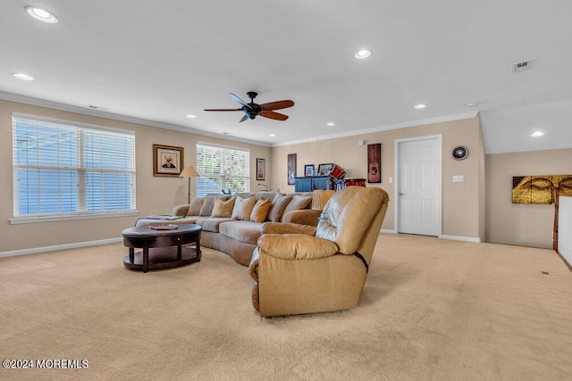 living room featuring light carpet, ornamental molding, and ceiling fan