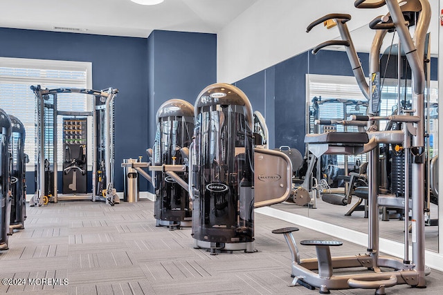 workout area featuring light colored carpet