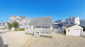 view of front of property featuring an outdoor structure, a garage, and a deck