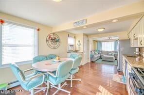 dining space featuring hardwood / wood-style flooring and sink