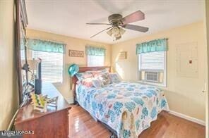 bedroom with ceiling fan and hardwood / wood-style floors