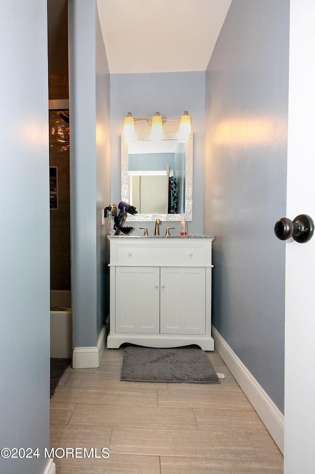 bathroom with vanity and hardwood / wood-style flooring