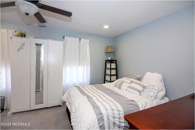 bedroom with light carpet and ceiling fan