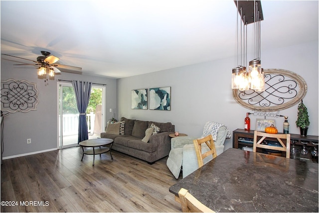 living room with wood-type flooring and ceiling fan