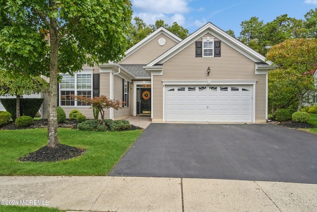 view of front of home featuring a garage and a front lawn