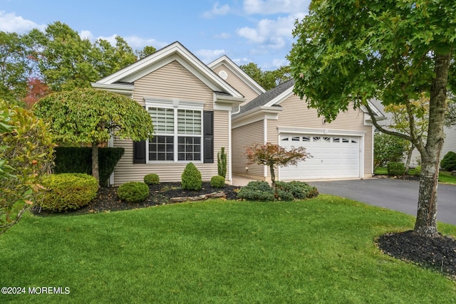 view of front facade with a front lawn and a garage