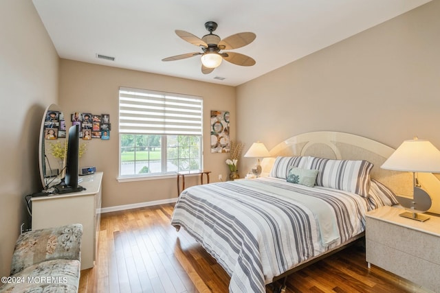 bedroom with ceiling fan and dark hardwood / wood-style floors