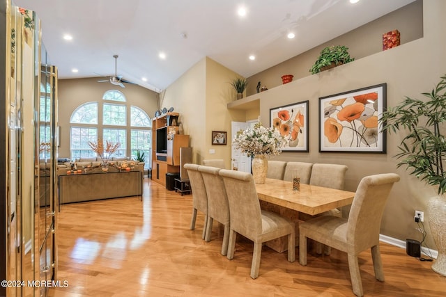 dining space featuring ceiling fan, light hardwood / wood-style floors, and vaulted ceiling