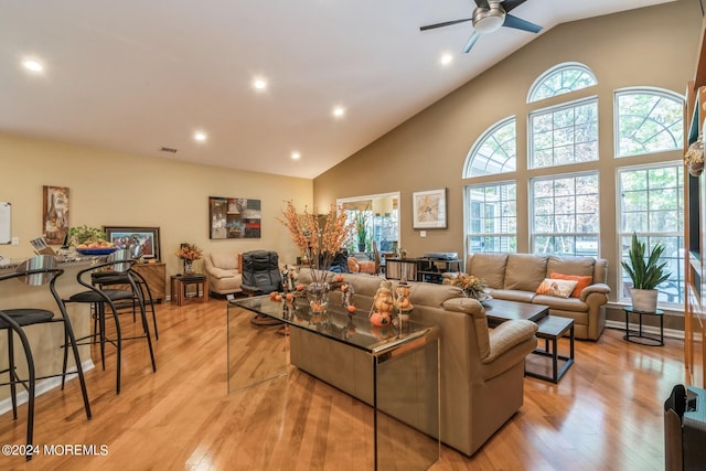 living room featuring ceiling fan, light hardwood / wood-style floors, and a healthy amount of sunlight