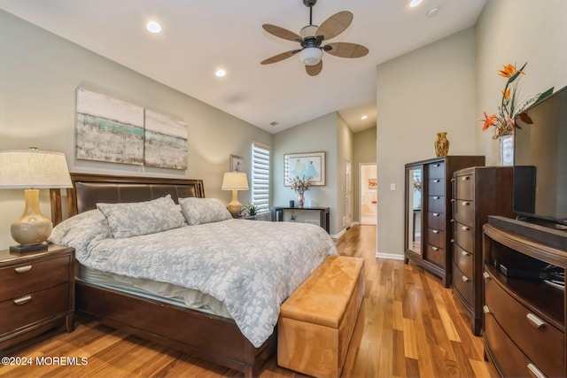 bedroom featuring ceiling fan, lofted ceiling, and light hardwood / wood-style floors