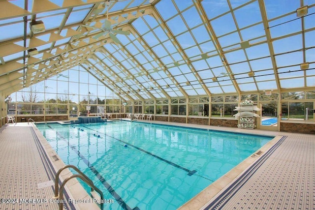 view of swimming pool with glass enclosure