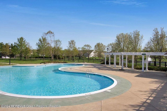 view of swimming pool featuring a pergola and a patio