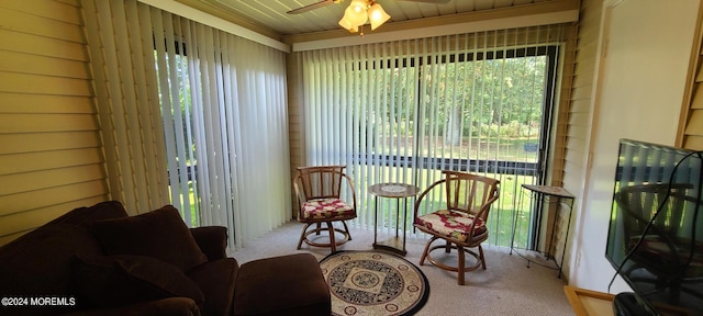 sunroom featuring ceiling fan and wood ceiling