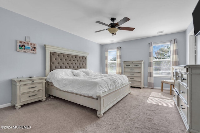 bedroom with light colored carpet and ceiling fan