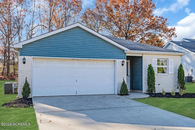 ranch-style home featuring a garage and central AC