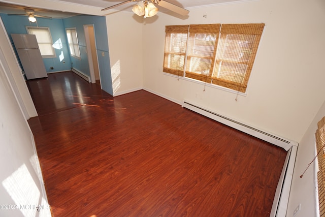 unfurnished room featuring dark wood-type flooring, ceiling fan, and a baseboard radiator