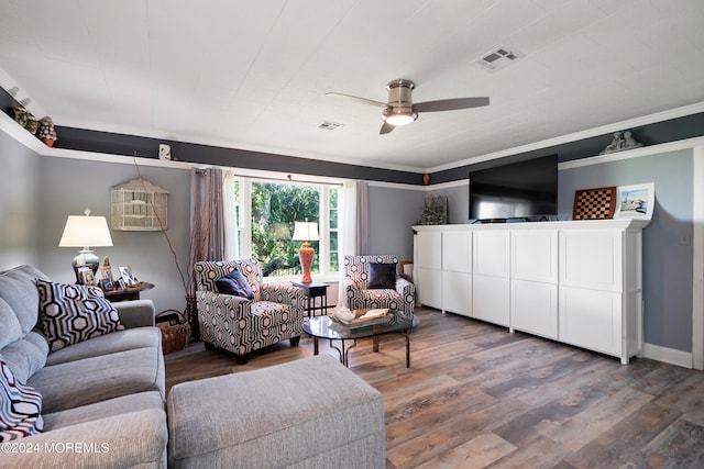 living room with hardwood / wood-style flooring, crown molding, and ceiling fan