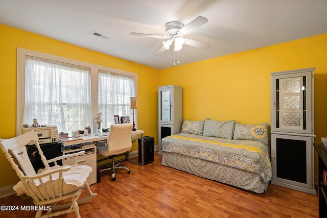 bedroom with light wood-type flooring and ceiling fan