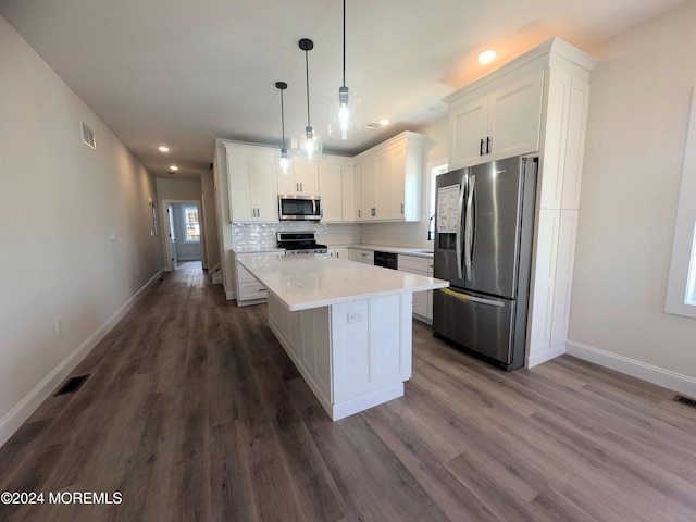 kitchen featuring dark hardwood / wood-style floors, a center island, decorative light fixtures, white cabinetry, and appliances with stainless steel finishes