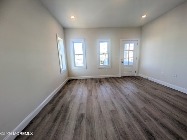 unfurnished room featuring dark wood-type flooring