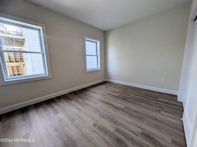 unfurnished bedroom with hardwood / wood-style flooring