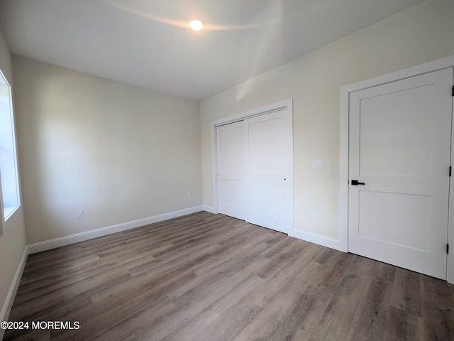 unfurnished bedroom featuring a closet and light wood-type flooring