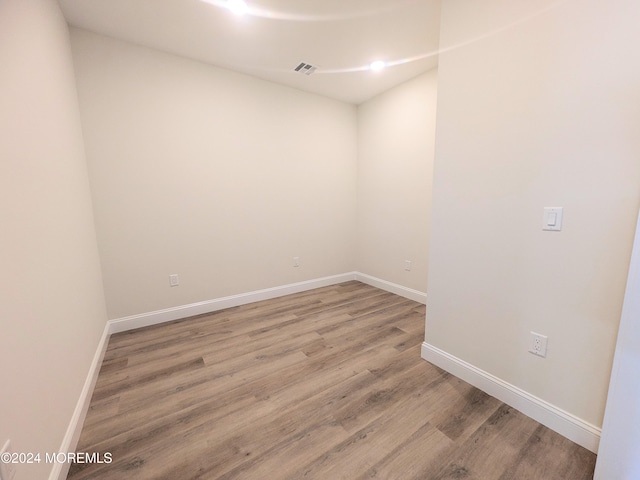 spare room with hardwood / wood-style flooring