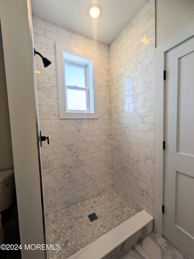 bathroom with tiled shower