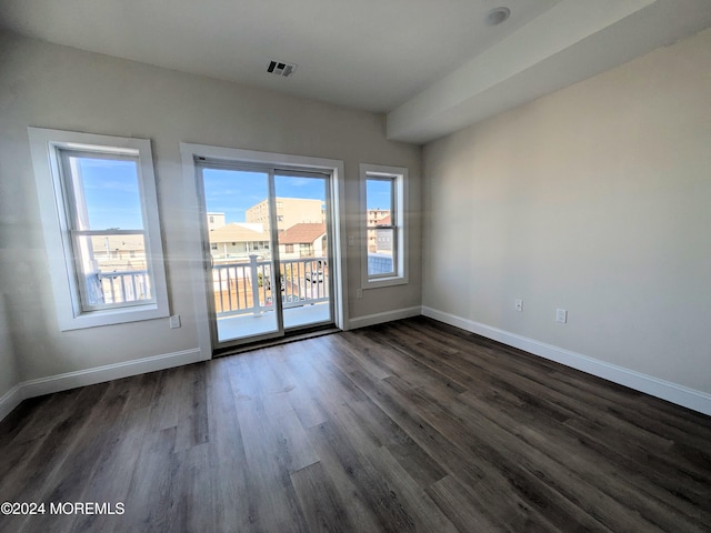 unfurnished room featuring dark hardwood / wood-style flooring