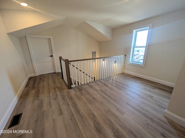 bonus room with vaulted ceiling and hardwood / wood-style floors