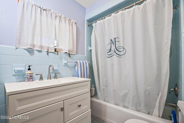 full bathroom featuring tile walls, vanity, shower / bath combination with curtain, and toilet