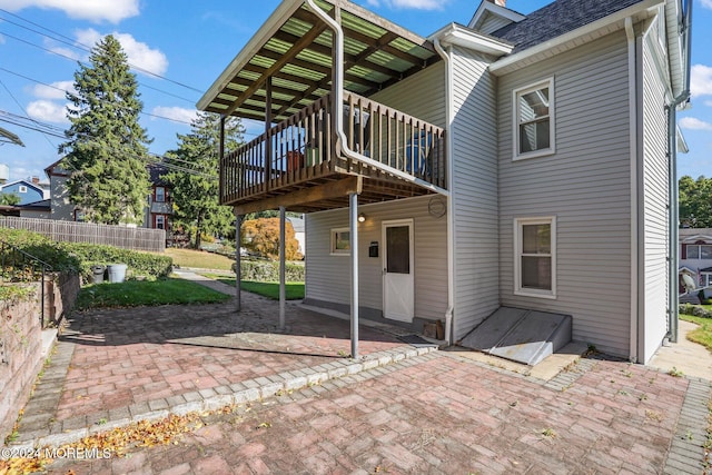 rear view of house featuring a patio and a deck