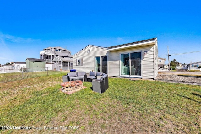 rear view of house featuring outdoor lounge area, a shed, a patio, and a lawn