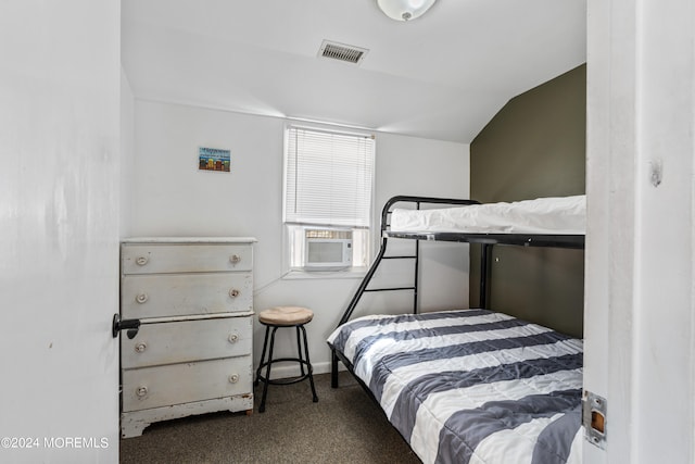 bedroom with lofted ceiling, carpet floors, and cooling unit