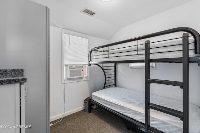 bedroom with cooling unit, lofted ceiling, and carpet floors