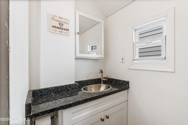 bathroom featuring vanity and vaulted ceiling