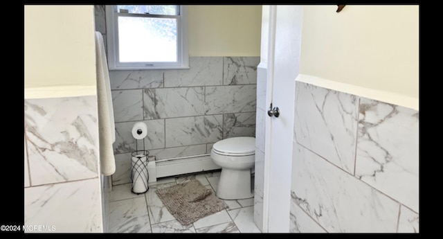 bathroom featuring tile walls, a baseboard heating unit, and toilet