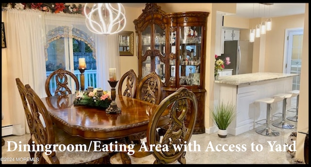 dining room with light tile patterned floors, an inviting chandelier, and baseboard heating