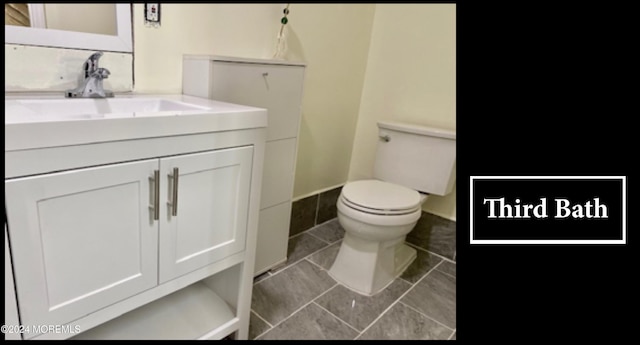 bathroom with vanity, toilet, and tile patterned floors