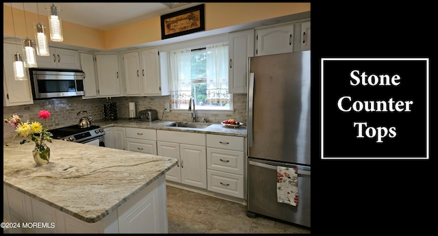 kitchen with pendant lighting, sink, white cabinets, and stainless steel appliances