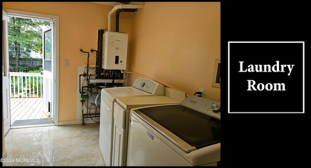 clothes washing area with tankless water heater and washer and clothes dryer